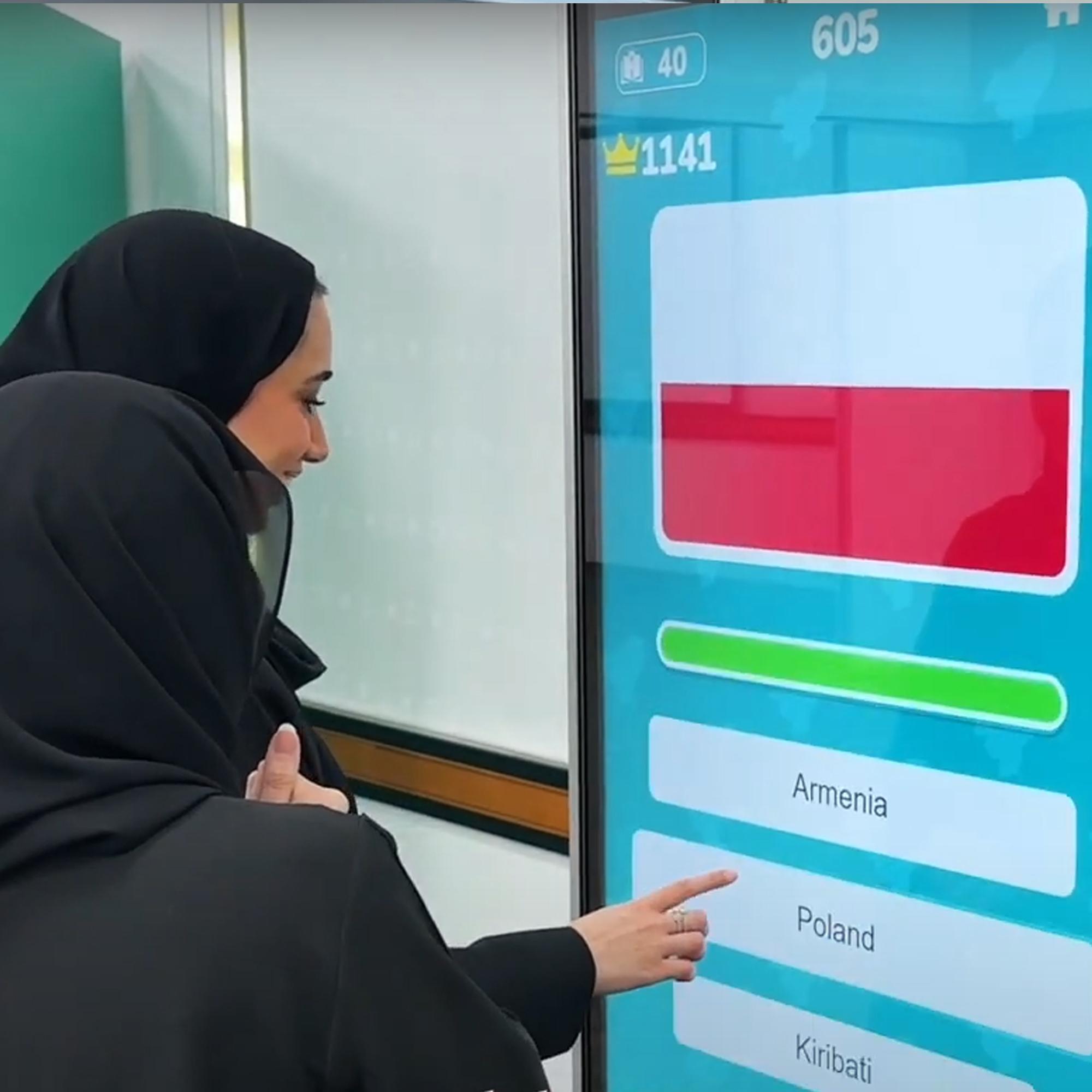 Participants playing the interactive Guess the Flag game at an event, engaging with a fun, branded quiz experience that tests geographical knowledge in a lively setting.